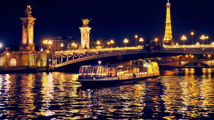 Une péniche navigant sur la seine la nuit